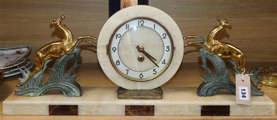 An Art Deco style onyx, marble and spelter mantel clock length 64cm